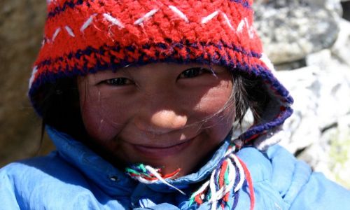 Smiling girl, Nepal. Alpin Technik Leipzig pays the whole rent of the Dolpo Hostel in Khatmandu for 1 year. Founded in 2008, the Hostel enables children from poor regions to visit school in Khatmandu.